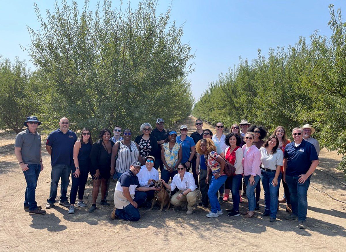 Group photo of tour group in orchard